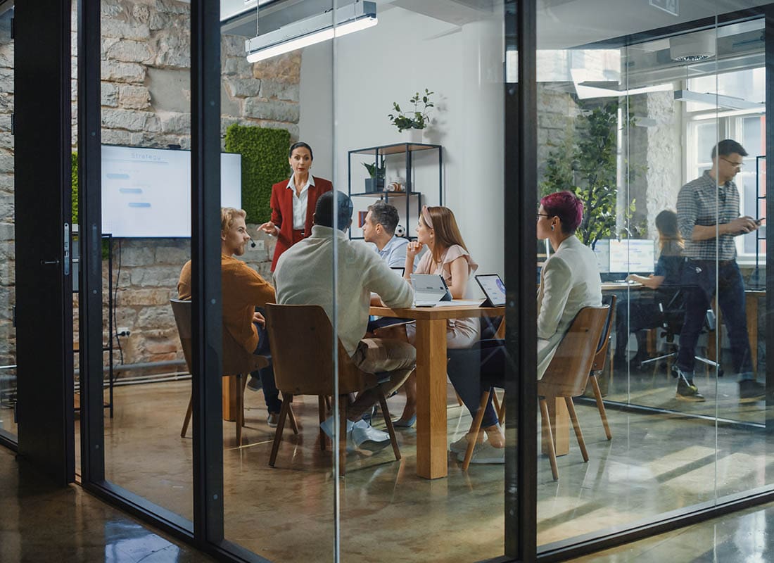 Business Insurance - Employees Having a Meeting in a Modern Conference Room
